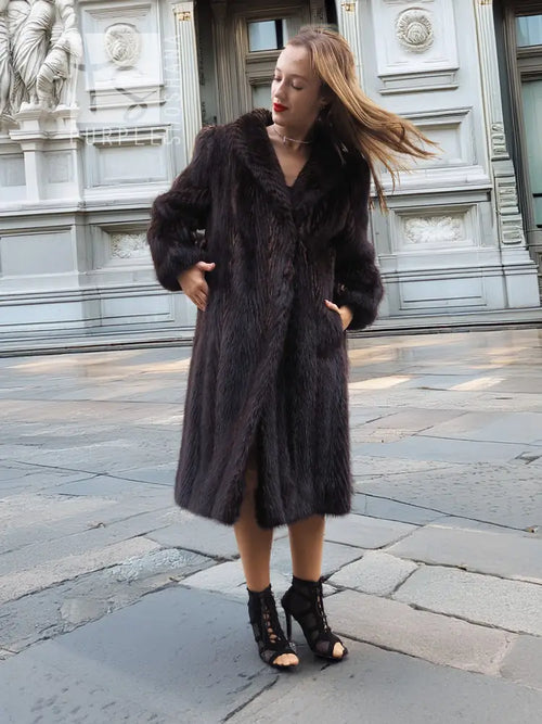 Two-tone muskrat fur coat with notched front, long sleeves and midi hem