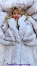 Plush light fur coat close-up with oversized hood and thick textured trim