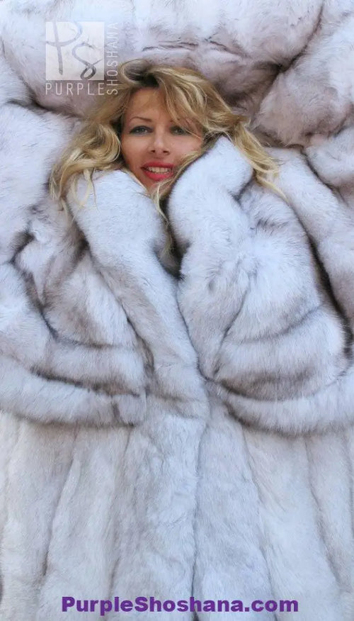 Plush light fur coat close-up with oversized hood and thick textured trim