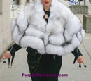 Plush light fur hooded coat worn over black top, wide wrap collar