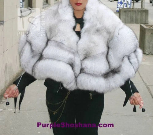 Plush light fur hooded coat worn over black top, wide wrap collar