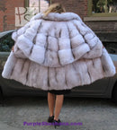 Plush light fur hooded coat with structured shoulder cape and quilted panel look