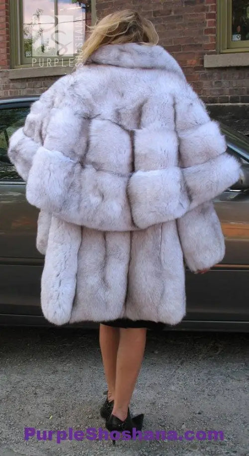 Plush light fur hooded cape-style coat with voluminous collar and back panel