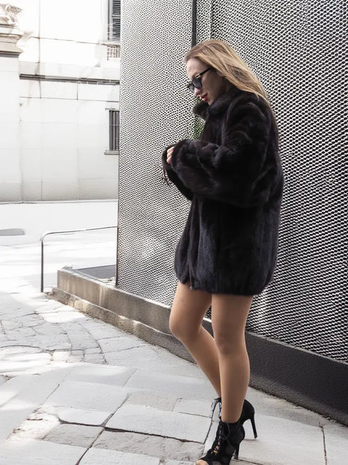 Dark mink fur bomber jacket with wide sleeves, stand collar, and front button placket.