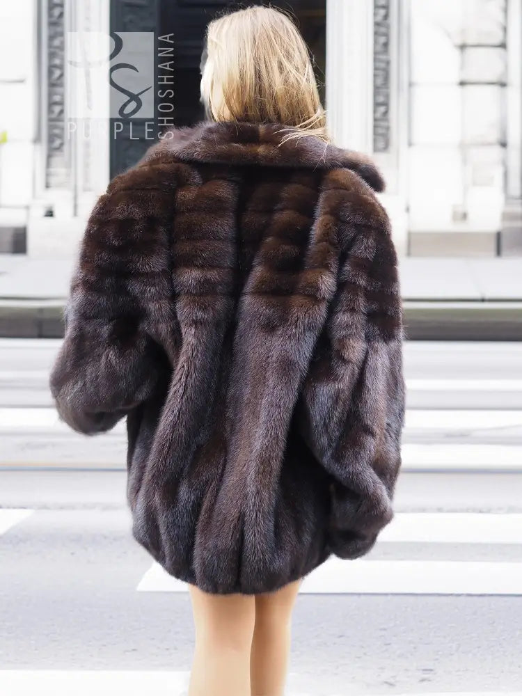 Mahogany mink fur bomber jacket with back yoke, plush fur panels, and short hem.