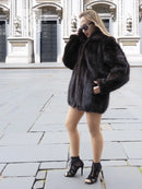 Dark mink fur bomber jacket with front snap closure, ribbed cuffs, and stand collar.
