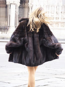Unisex mink fur bomber jacket in dark tone, full sleeves with voluminous fur collar.
