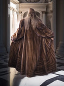 Back view of mahogany brown mink fur coat with long sleeves and flared hem.