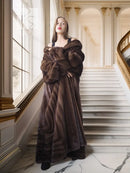 Mahogany brown mink fur coat with oversized collar and open front, standing on staircase.