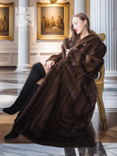 Dark brown mink fur coat with shawl-style collar, seated full-length view