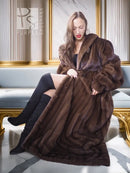 Mahogany brown mink fur coat with shawl collar and layered fur texture, seated pose.