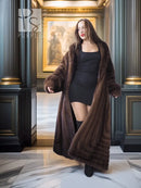 Mahogany brown mink fur coat with open front and long hem, standing in hallway view.