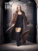 Mahogany mink fur coat with open front and stand collar over a black slip dress