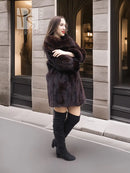 Dark brown mink fur coat with wide collar and full skirt silhouette, side view
