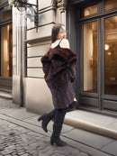 Dark brown fur coat with wide shoulder collar and long sleeves, styled with black boots.