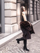 Dark brown mink fur coat with wide collar and layered sleeves, walking away view