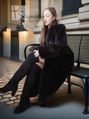 Black mink fur coat with plush hooded neckline and fold-back cuffs
