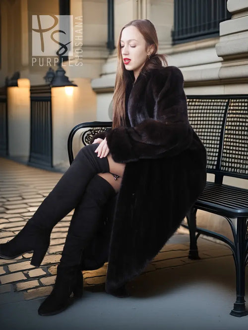 Black mink fur coat with plush hooded neckline and fold-back cuffs