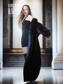 Dark mink fur coat with fold-back cuffs, draped sleeves over one shoulder
