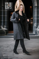 Dark mink coat with wide turn-back collar, button details, and short sleeves