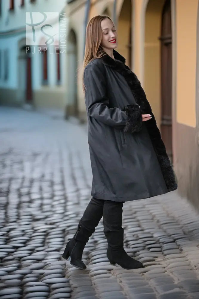 Dark fur coat with button placket and long sleeves, side view