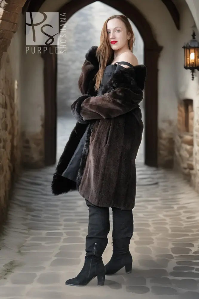 Long dark mink coat with fur hood/collar, button front, and plush fur-trimmed sleeves