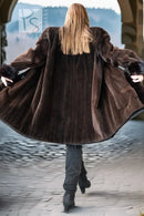 Mink coat back view with button closure and voluminous sleeves