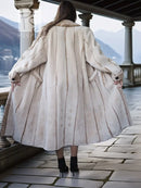 Back view of cream sheared beaver fur coat with gathered back yoke and flared hem