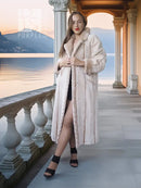 Cream fur coat with open front and shawl collar; long sleeves and mid-calf hem.