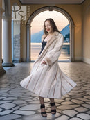 Cream fur coat with open front, long sleeves, and a swinging mid-calf hem.