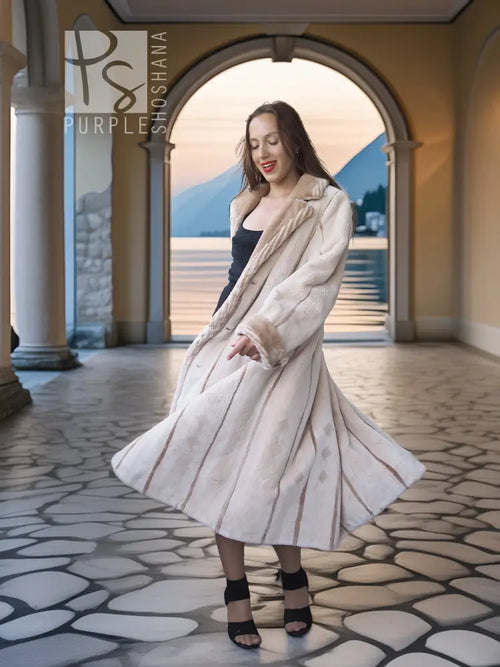 Cream fur coat with open front, long sleeves, and a swinging mid-calf hem.