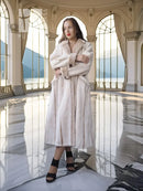 Cream sheared beaver fur coat with open front, notched collar, and cuffed sleeves