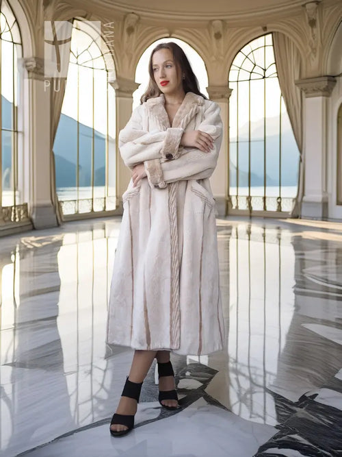 Cream sheared beaver fur coat with open front, notched collar, and cuffed sleeves