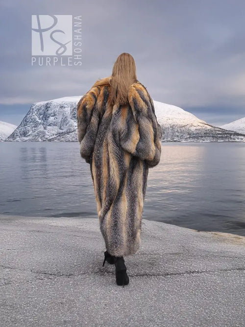 Back view of long gray and amber fox fur coat with full, flowing silhouette.