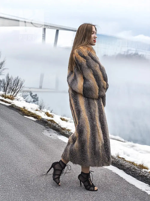 Side view of long gray and amber fox fur coat with full sleeves and ankle length.