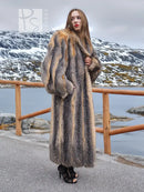 Long gray and amber fox fur coat, draped sleeves and full-length silhouette.