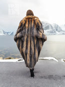 Vintage fox fur coat, back view, long gray and tan striped texture with voluminous sleeves.
