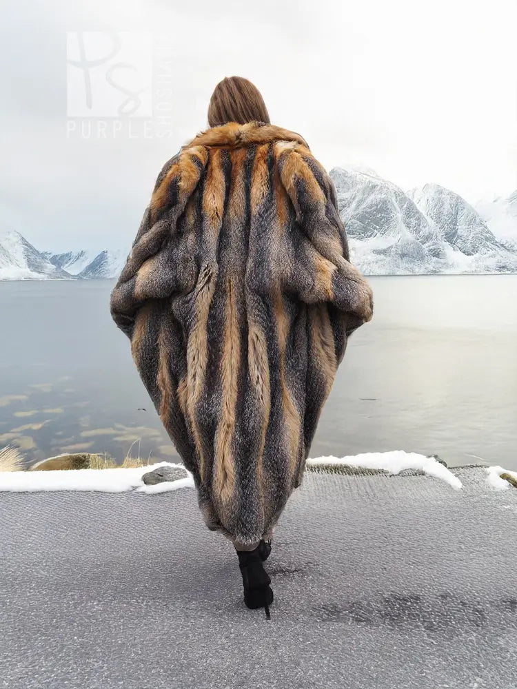 Vintage fox fur coat, back view, long gray and tan striped texture with voluminous sleeves.