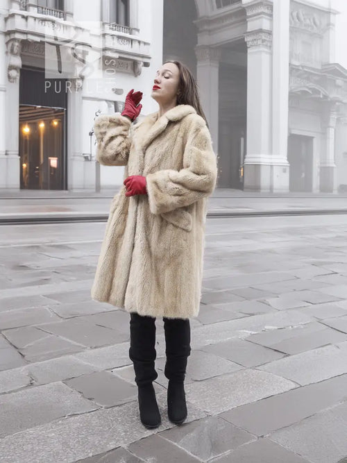Beige mink fur coat with stand collar and full, knee-length silhouette