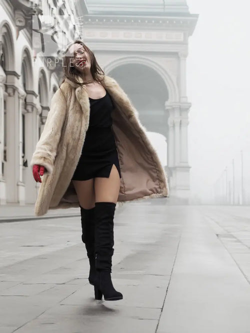 Beige mink fur coat over black dress, featuring open front and long sleeves