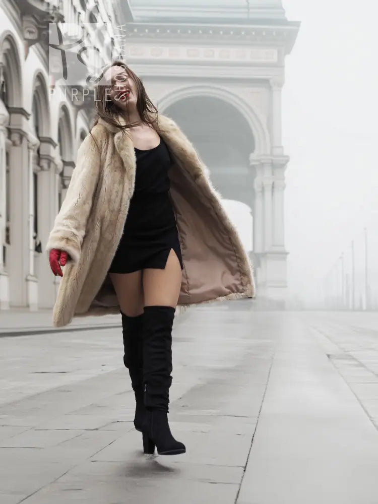 Beige mink fur coat over black dress, featuring open front and long sleeves
