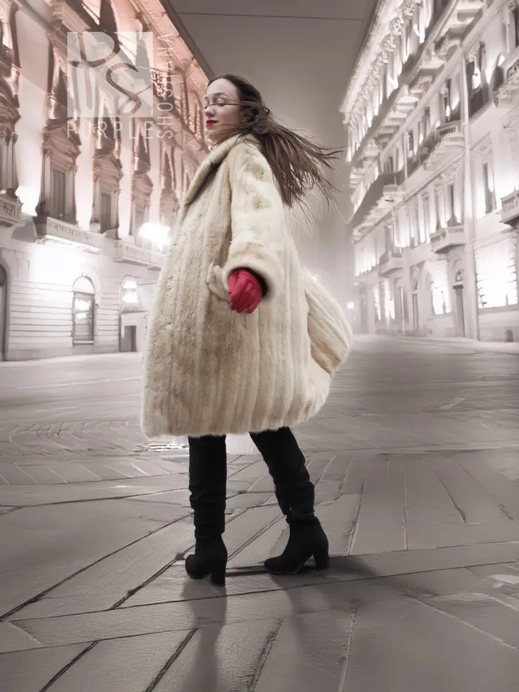 Beige mink fur coat in side view with open front and red cuffed gloves