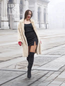 Beige mink fur coat worn over black dress, open front with plush beige fur