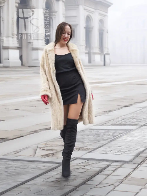 Beige mink fur coat worn over black dress, open front with plush beige fur