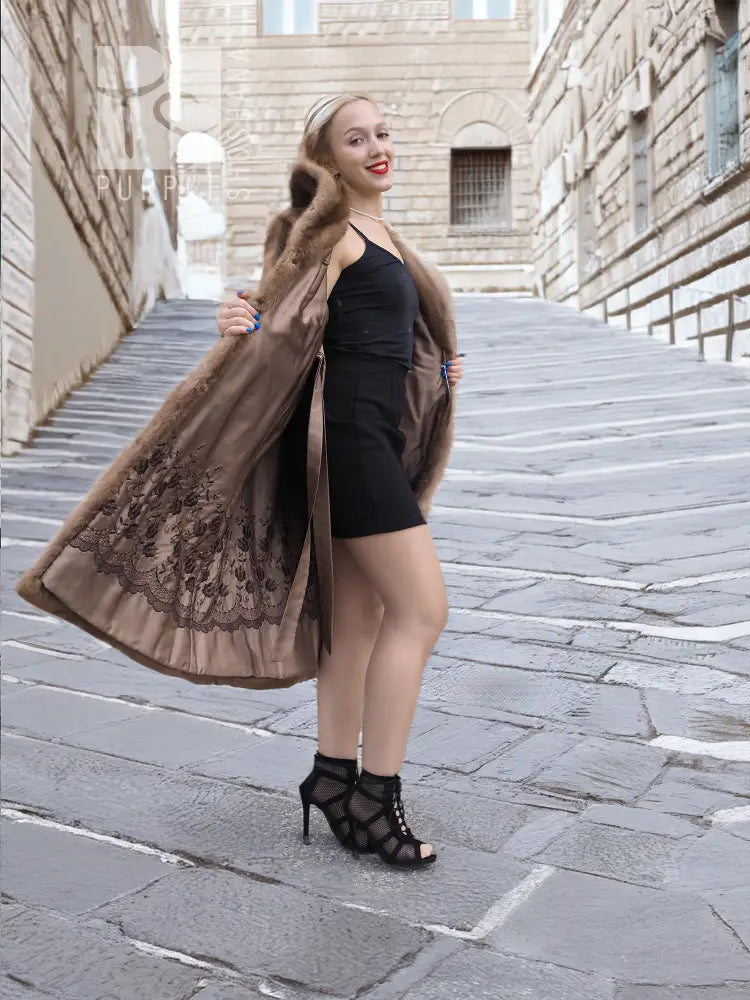 Brown mink fur coat with open front, flared skirt shape, worn over black dress
