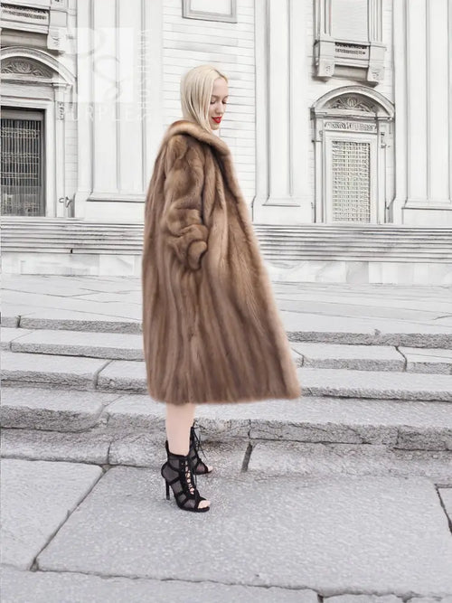 Brown mink fur coat with long straight silhouette and plush fur collar, side view