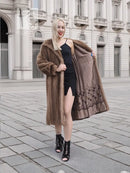 Brown mink fur coat with wide shoulders, open front, high collar; mid length.