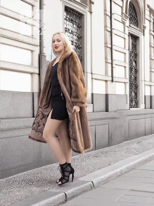 Brown mink fur coat with fur collar and open front, worn with black mini dress