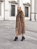 Brown mink fur coat with hood, long sleeves, midi length, side view.