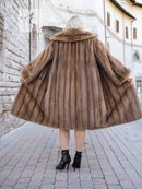 Brown mink fur coat back view, flared mid-calf hem, textured fur detail.